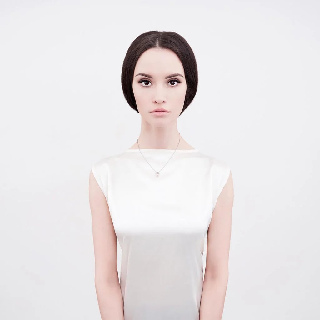 Fine-art studio portrait of a woman in soft light